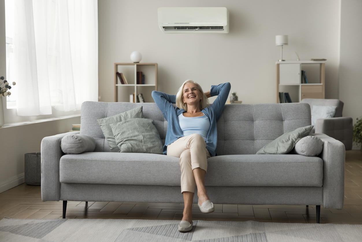 Senior Woman Relaxing in Room with Mini Split