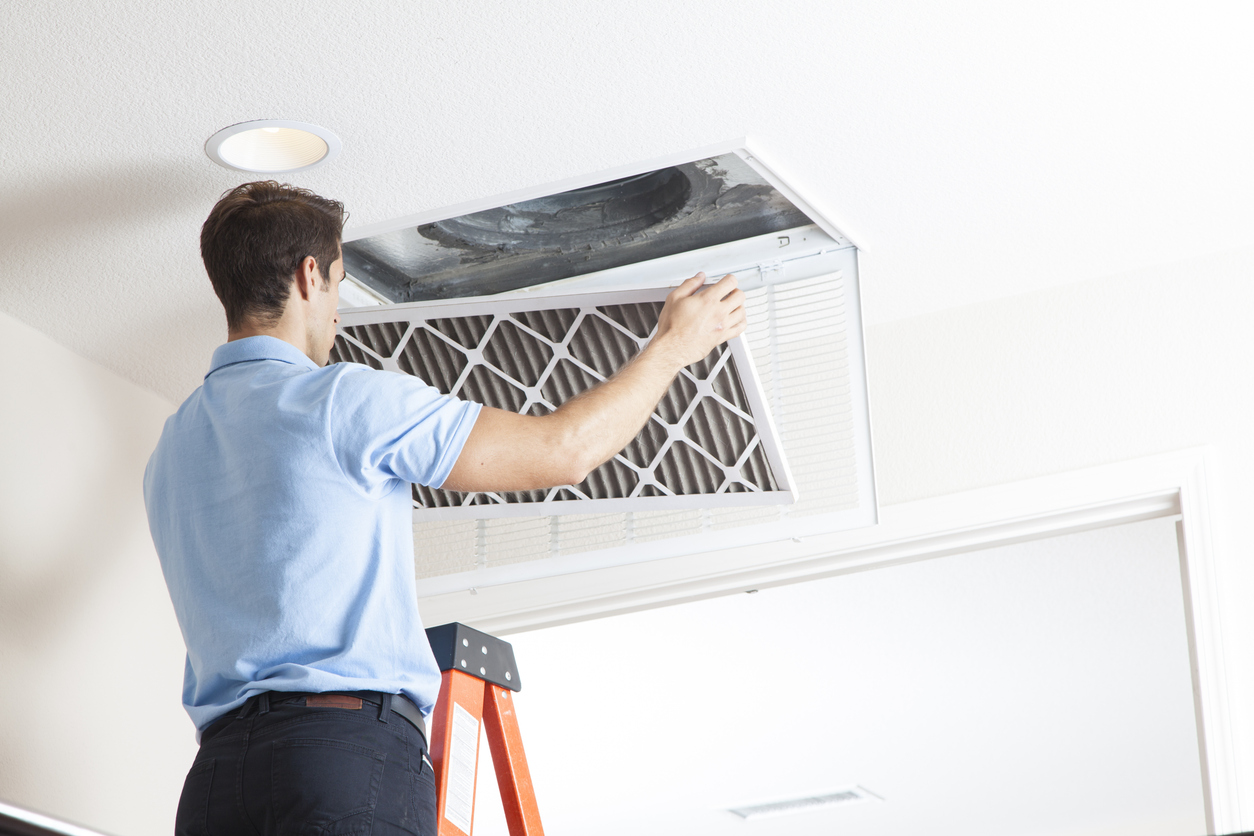 Technician Inspecting Dirty Air Duct