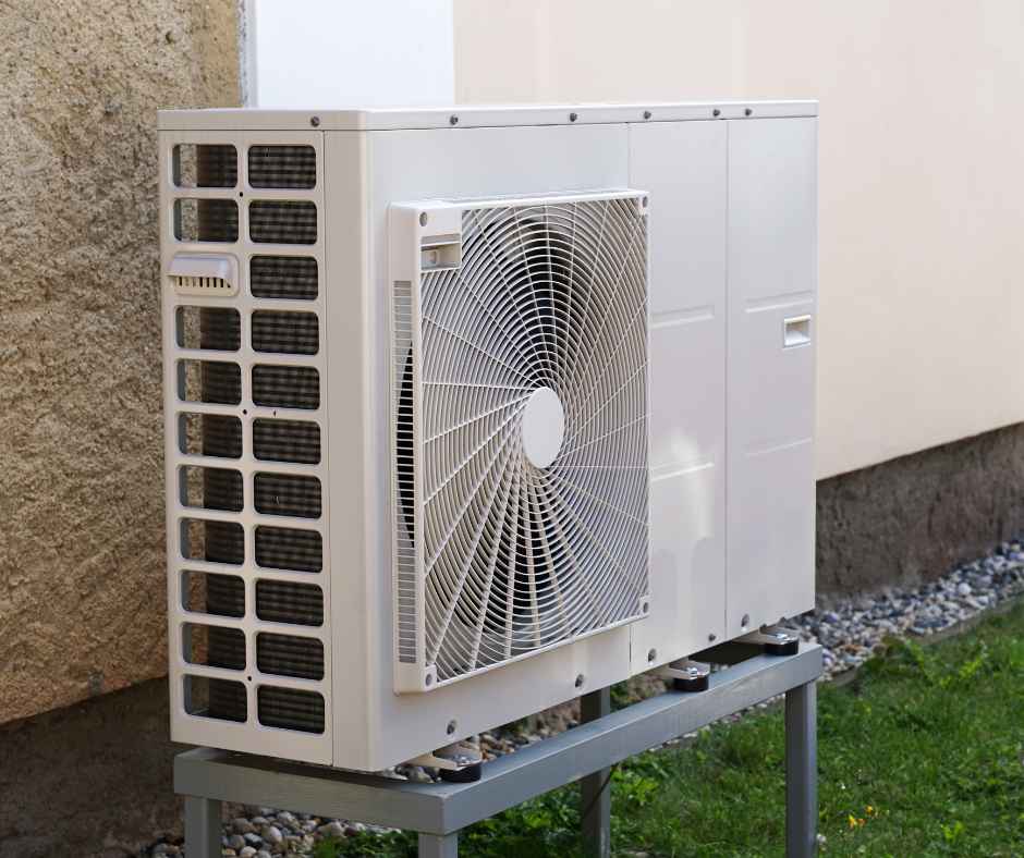 Heat pump outside a home on a stand
